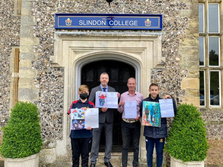 Slindon College pupils, art teacher and headmaster outside Slindon House with ISA artwork